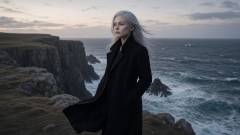 On a cliff at dusk above a dark ocean